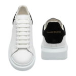 Alexander McQueen oversized sneakers feature a distinctive black suede heel counter with gold - Image 2