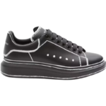 Alexander McQueen Oversized sneakers feature a sleek black calf leather upper contrasted by a bold white outline