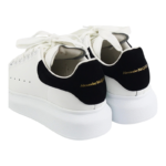 Alexander McQueen oversized sneakers feature a distinctive black suede heel counter with gold - Image 3