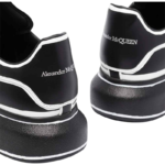 Alexander McQueen Oversized sneakers feature a sleek black calf leather upper contrasted by a bold white outline - Image 5