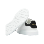 Alexander McQueen oversized sneakers feature a distinctive black suede heel counter with gold - Image 5
