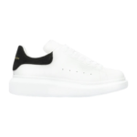 Alexander McQueen oversized sneakers feature a distinctive black suede heel counter with gold