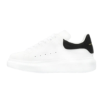 Alexander McQueen oversized sneakers feature a distinctive black suede heel counter with gold - Image 6