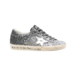 Golden Goose Super Star sneakers feature a silver glitter upper and signature leather star.