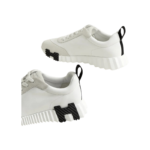 Hermès Bouncing sneakers feature white calfskin with a distinctive black "H" logo on the side. - Image 2